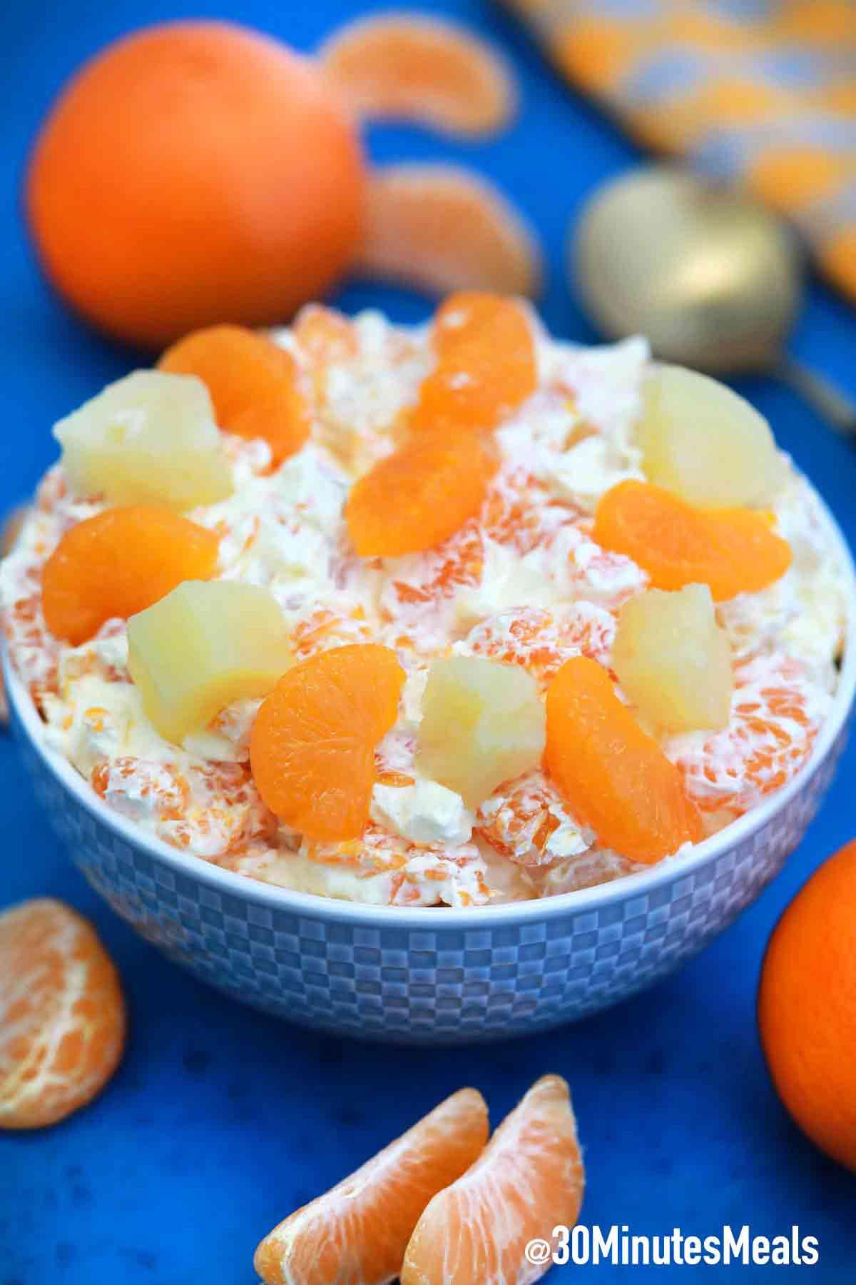 a bowl of mandarin orange swiss cheese salad being served