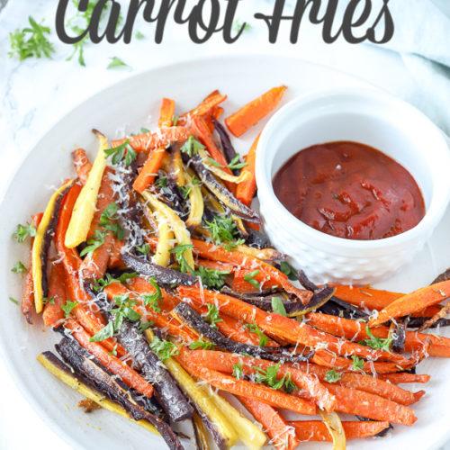a batch of colorful roasted carrot fries on a baking sheet
