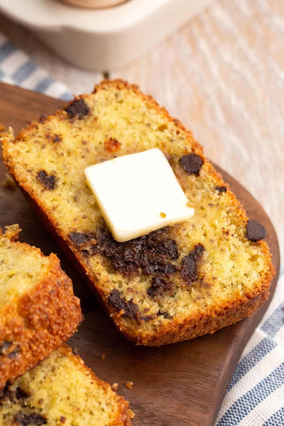 a slice of keto banana bread with a pat of butter melting on top