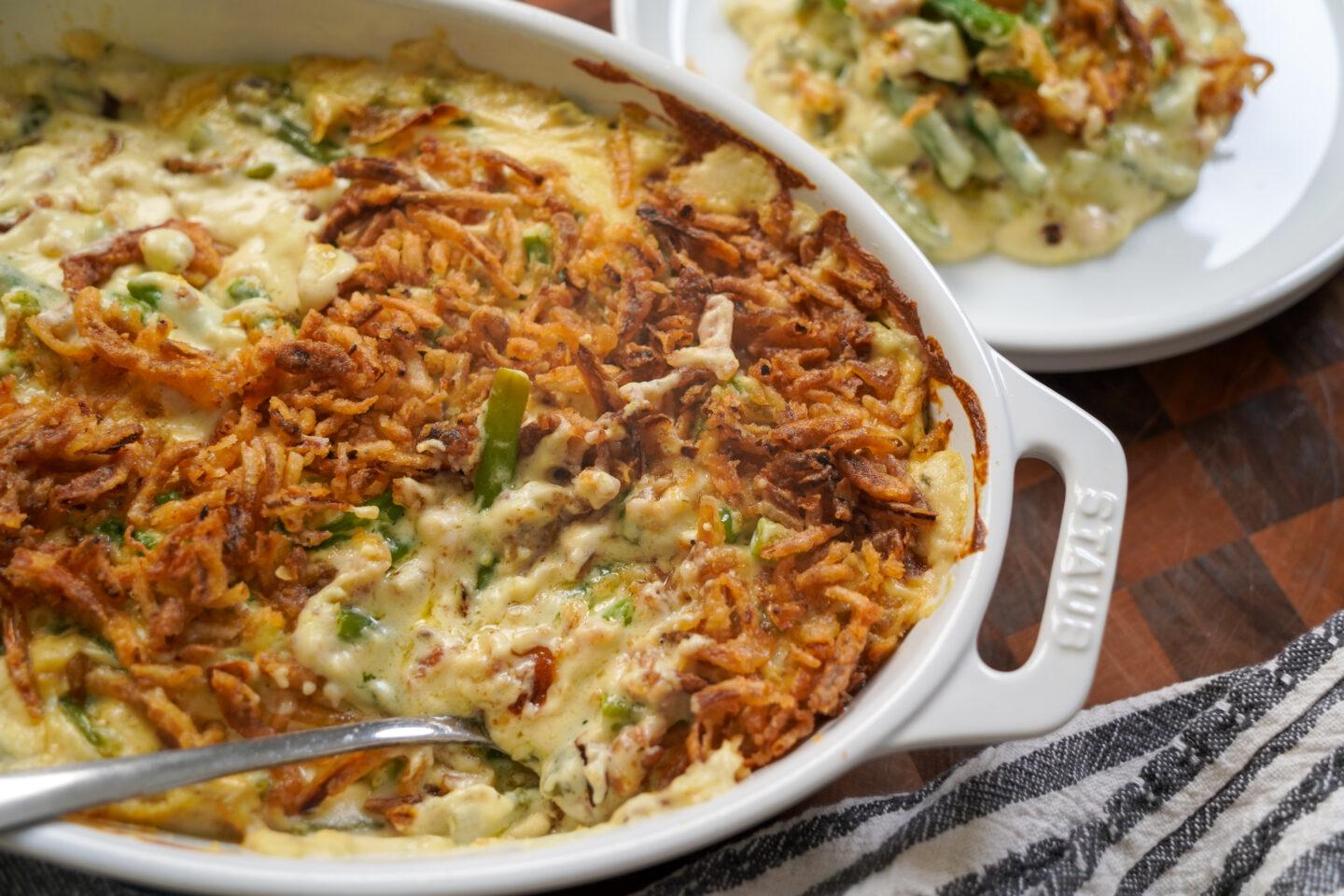 beautifully baked green bean casserole with golden crispy onions on top, a cozy kitchen setting