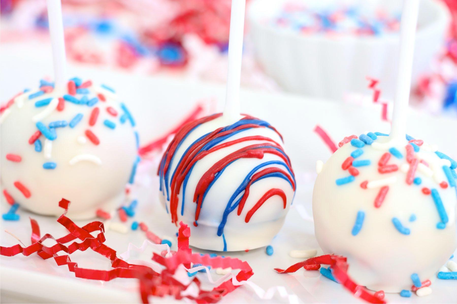close-up shot of red, white, and blue cake pops arranged on a platter