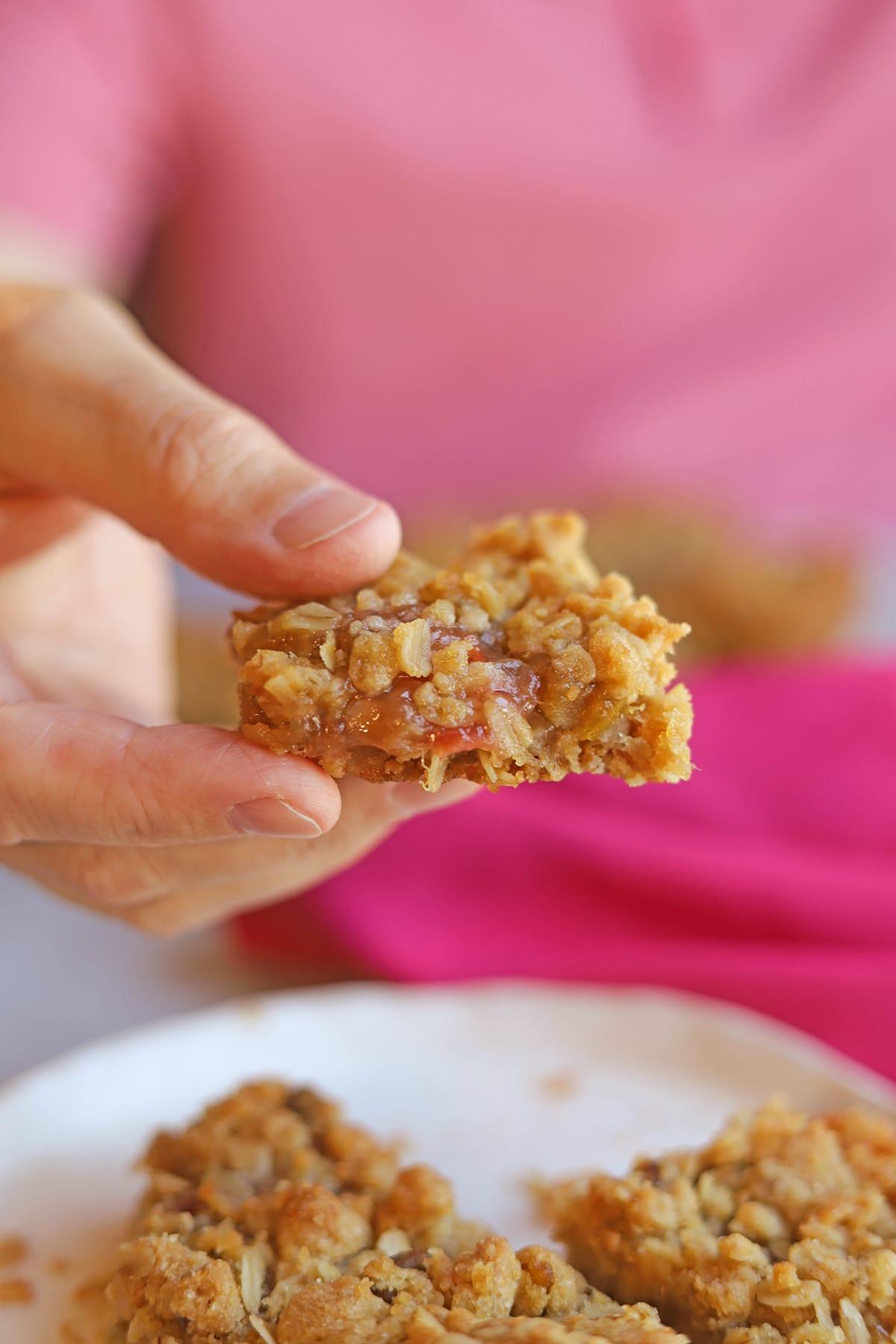 close up shot of the rhubarb almond bar in hand
