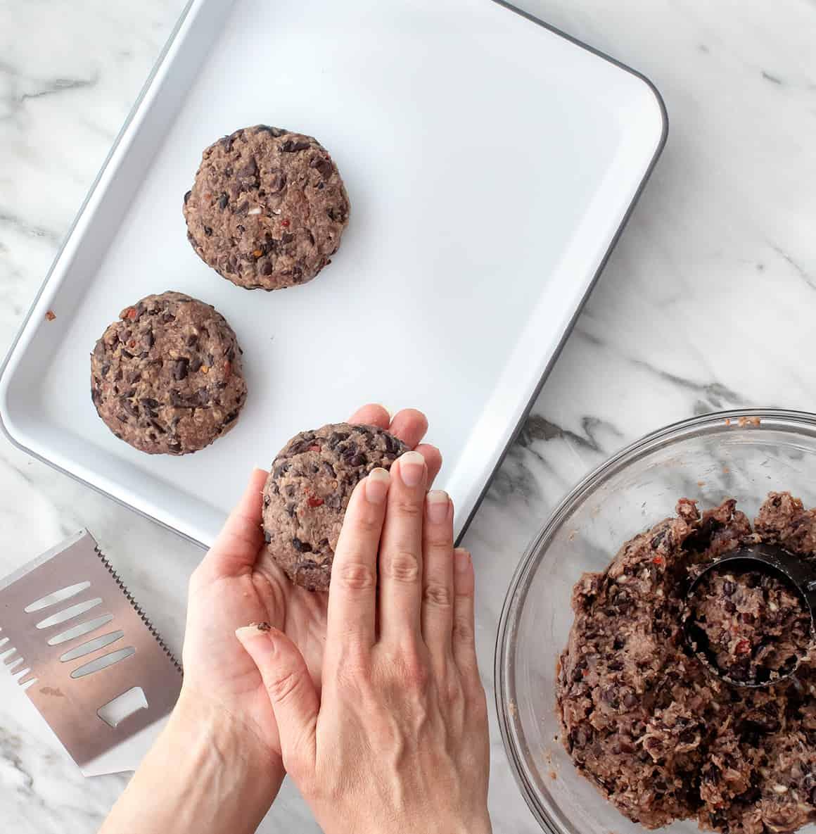 black bean burger patty being formed in hands