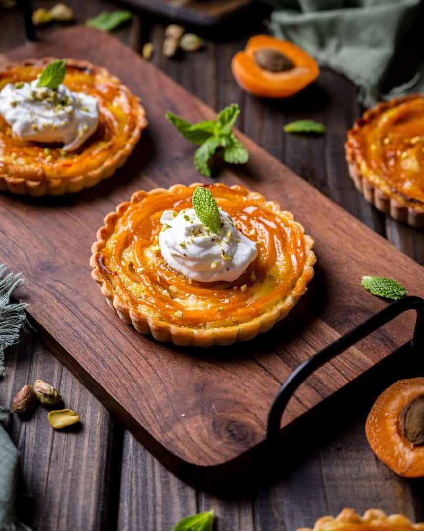 slice of apricot pistachio tart with a cup of coffee