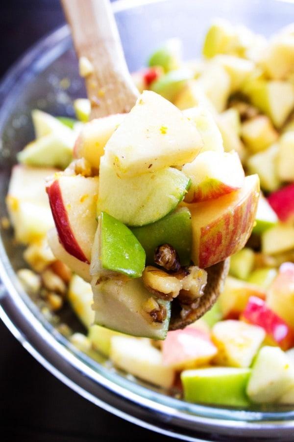 Vibrant apple walnut salad with honey drizzle on a rustic wooden table, bright natural light, crisp apples, crunchy walnuts