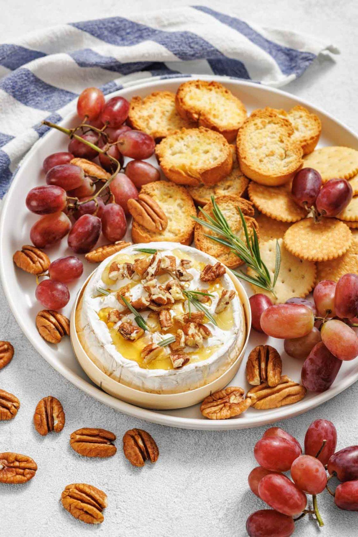 baked brie with honey and nuts on a wooden board, festive winter setting