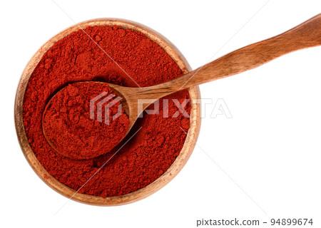 overhead shot of smoked paprika in a small wooden bowl