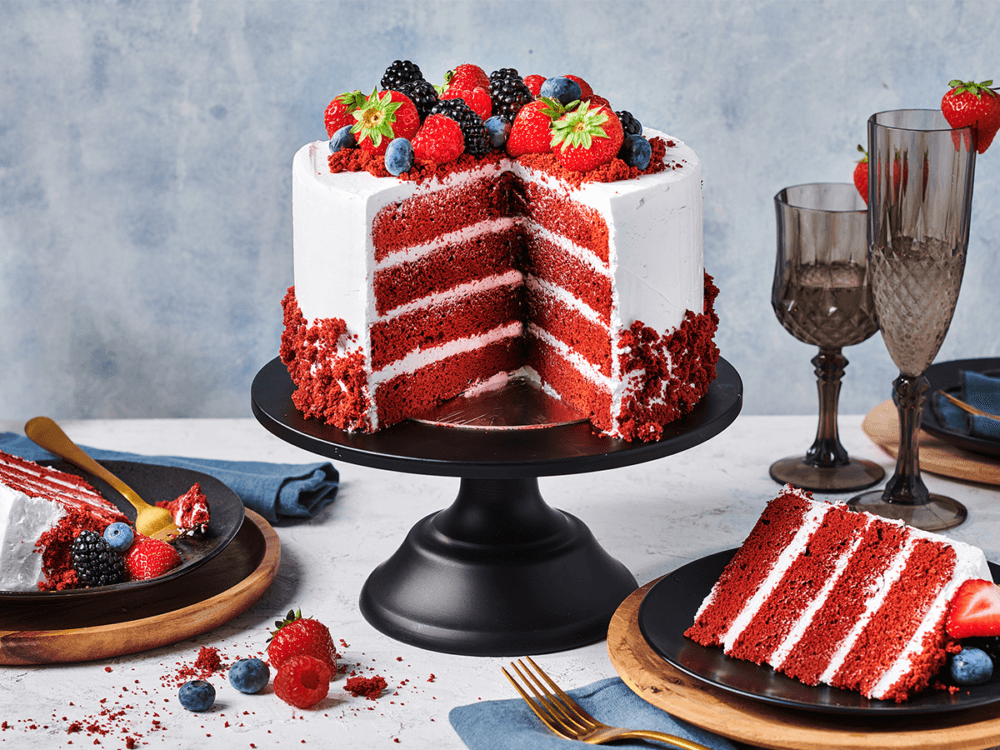 A group of people enjoying red velvet cake at a party