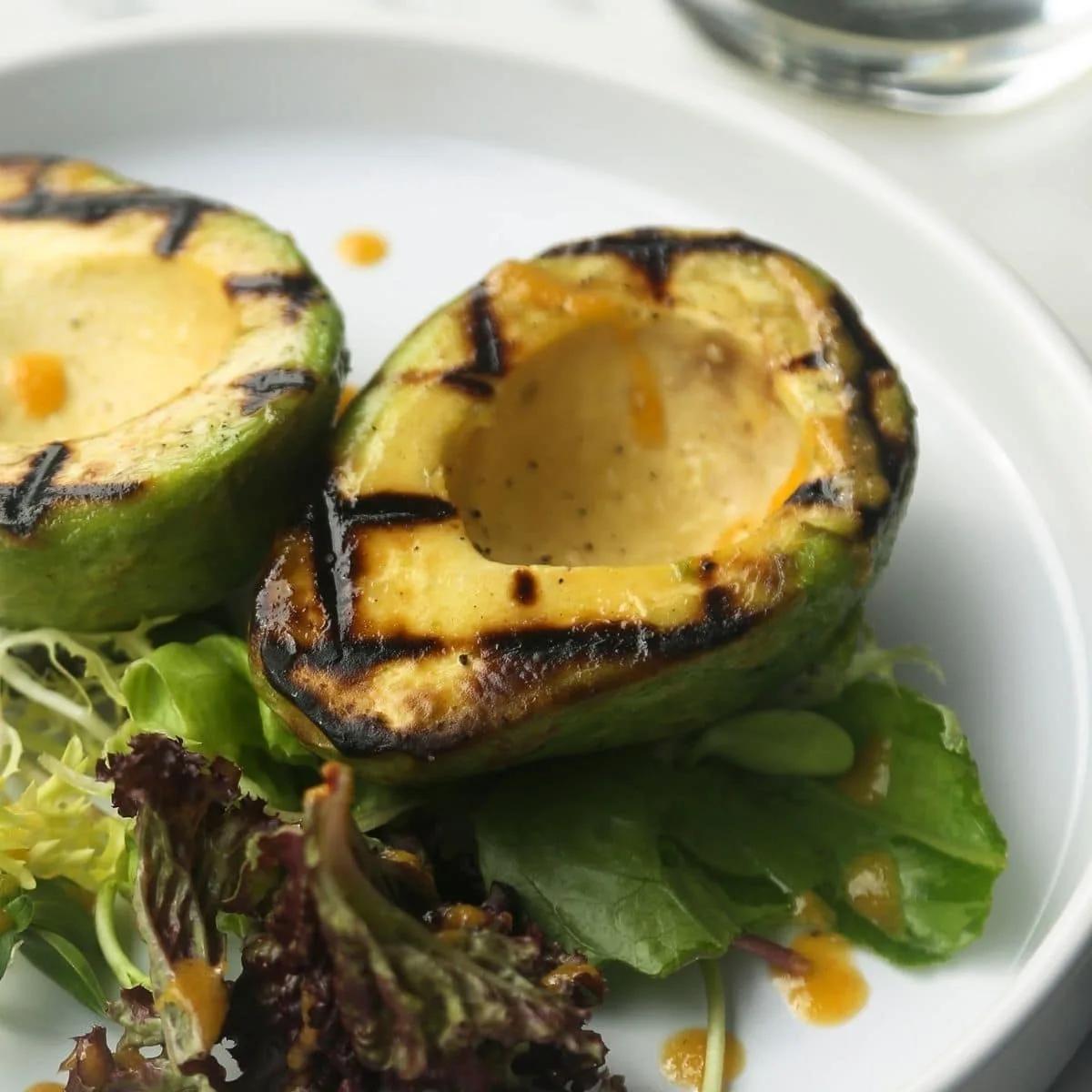 Close-up of grilling avocado halves with grill marks
