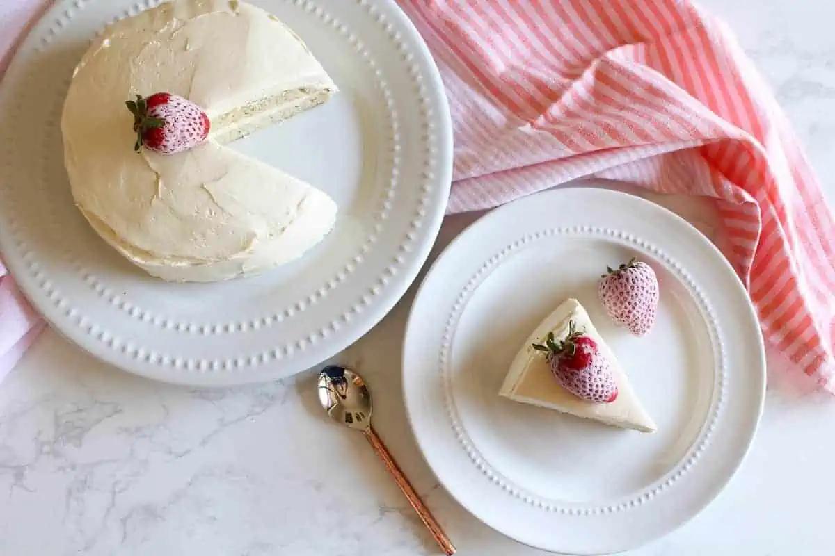 overhead shot of a slice of vanilla coconut flour birthday cake on a plate