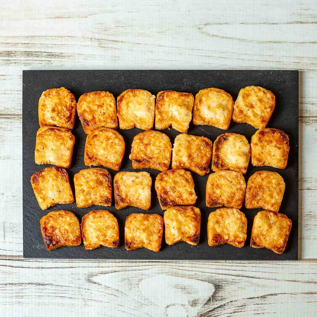 Variety of crispy parmesan bites artfully arranged on a serving tray