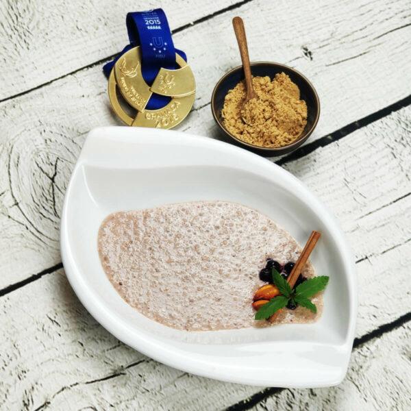 a hand stirring hemp seed protein powder into a bowl with other ingredients