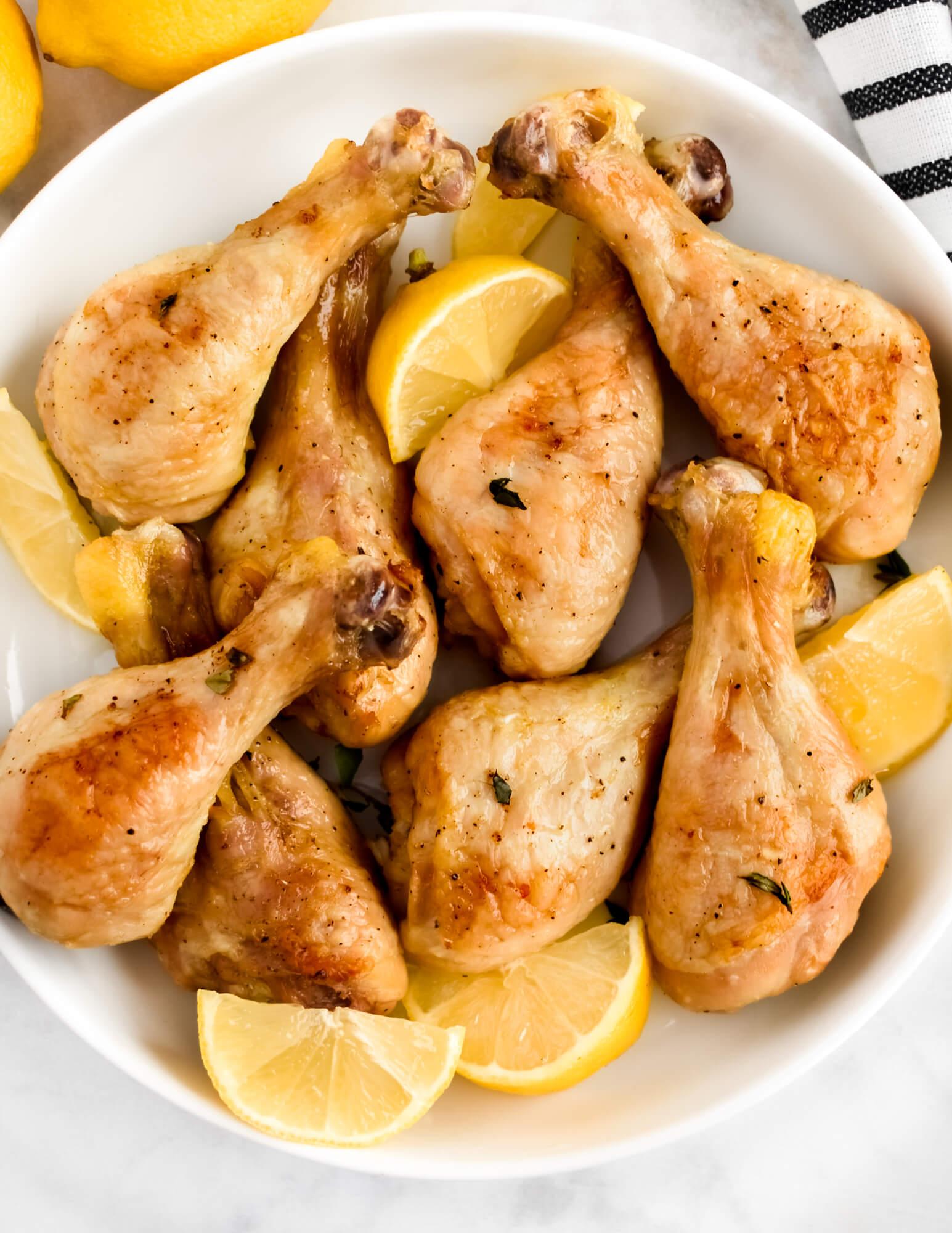 close up of lemon herb roasted chicken drumsticks on a plate