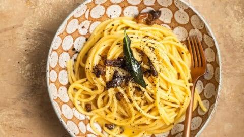 ingredients for carbonara with sage butter laid out on a wooden surface