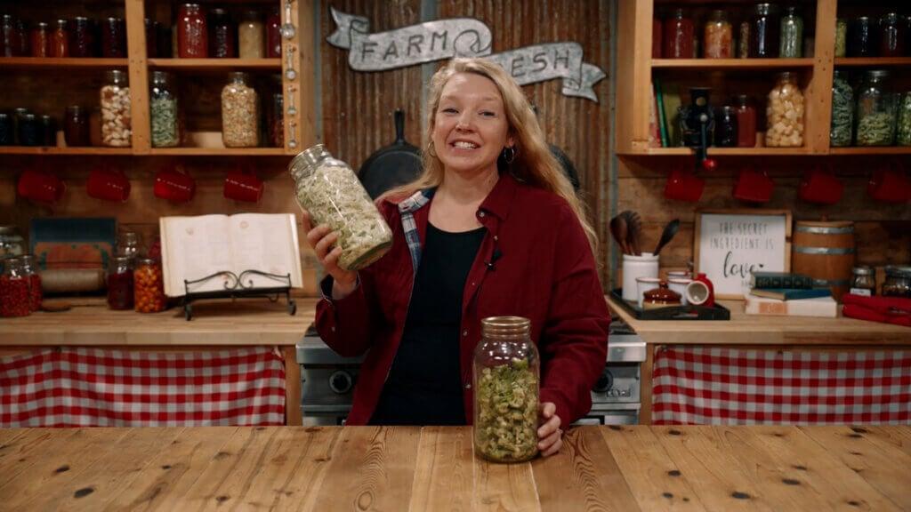 woman preparing alfalfa drink in kitchen