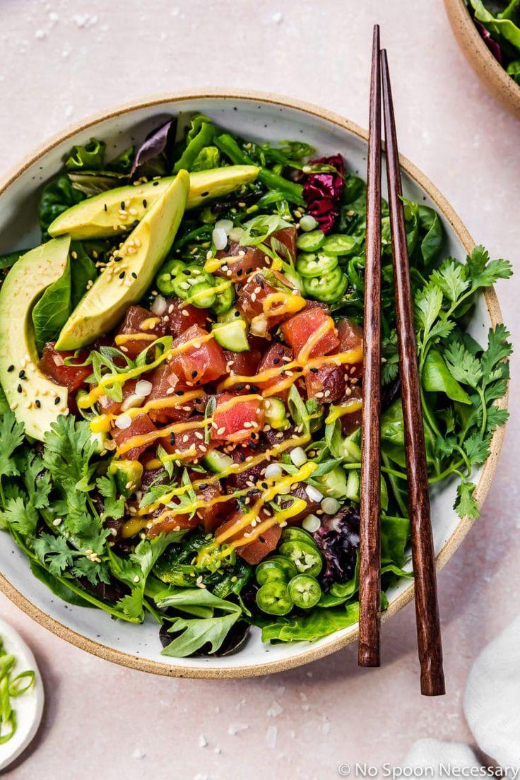 overhead shot of spicy tuna and avocado salad ingredients on a wooden board
