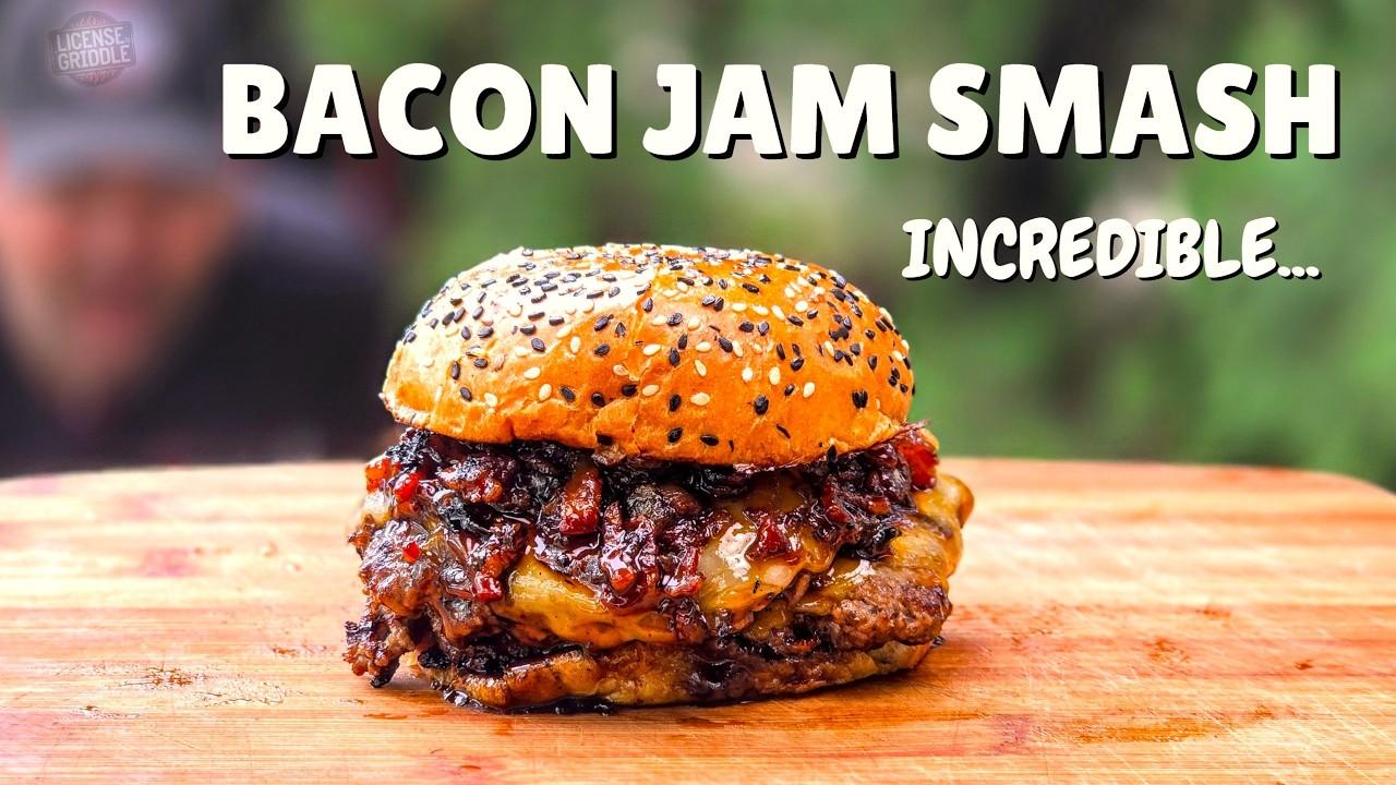 smash burgers cooking on a griddle with bacon jam on top