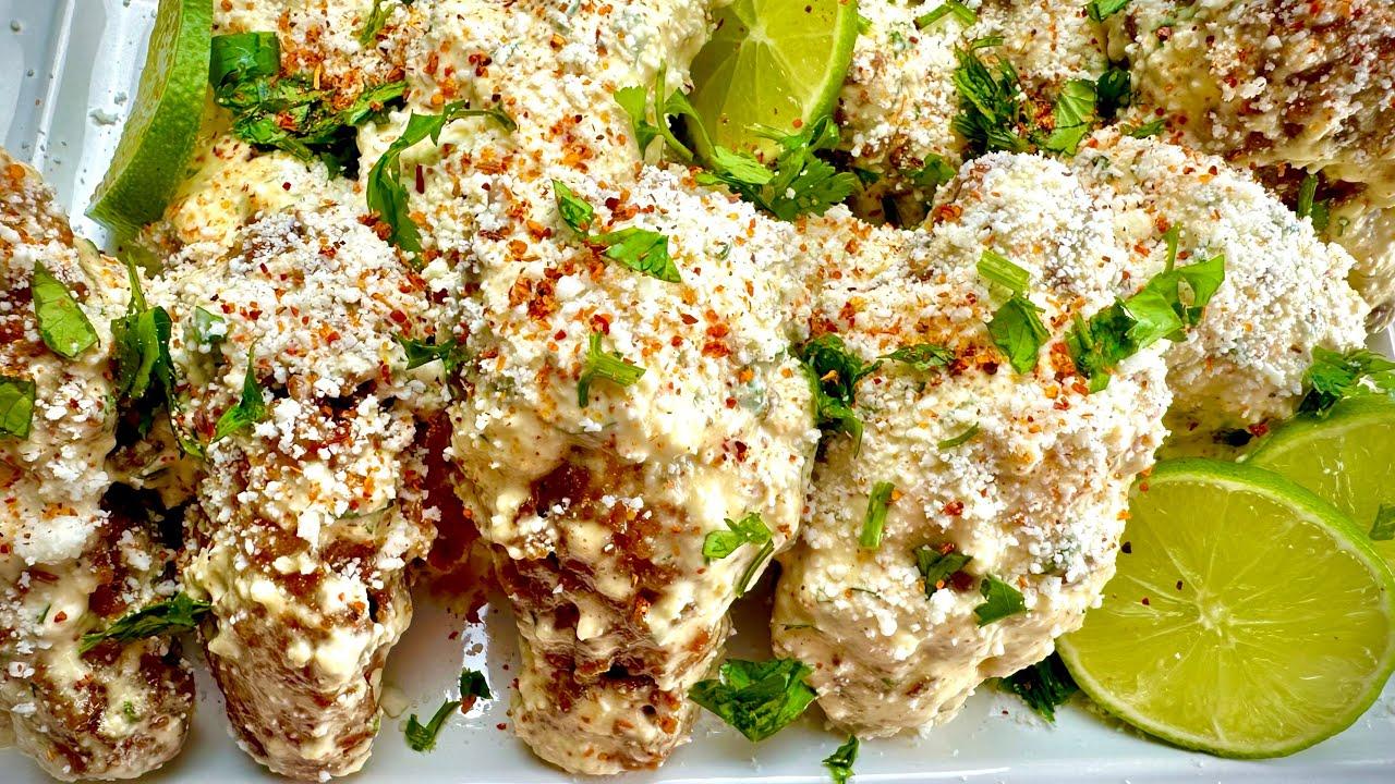 elote wings with lime and cilantro garnish
