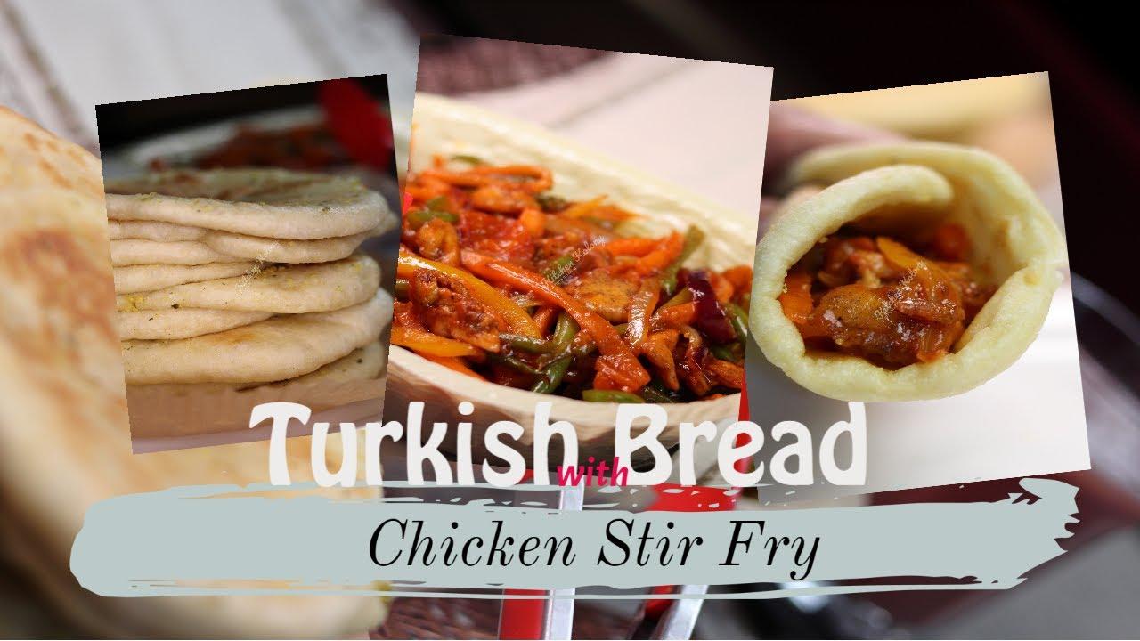 Close-up shot of chicken stir-fry being stuffed into a bread loaf