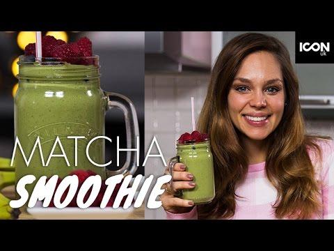 a person smiling while holding a vibrant green matcha smoothie