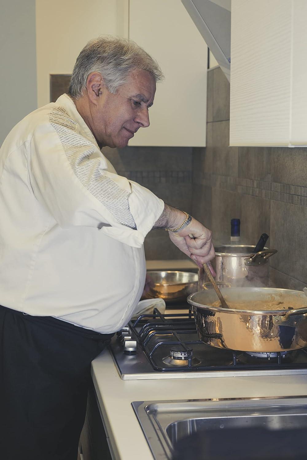 chef stirring risotto in a copper pot