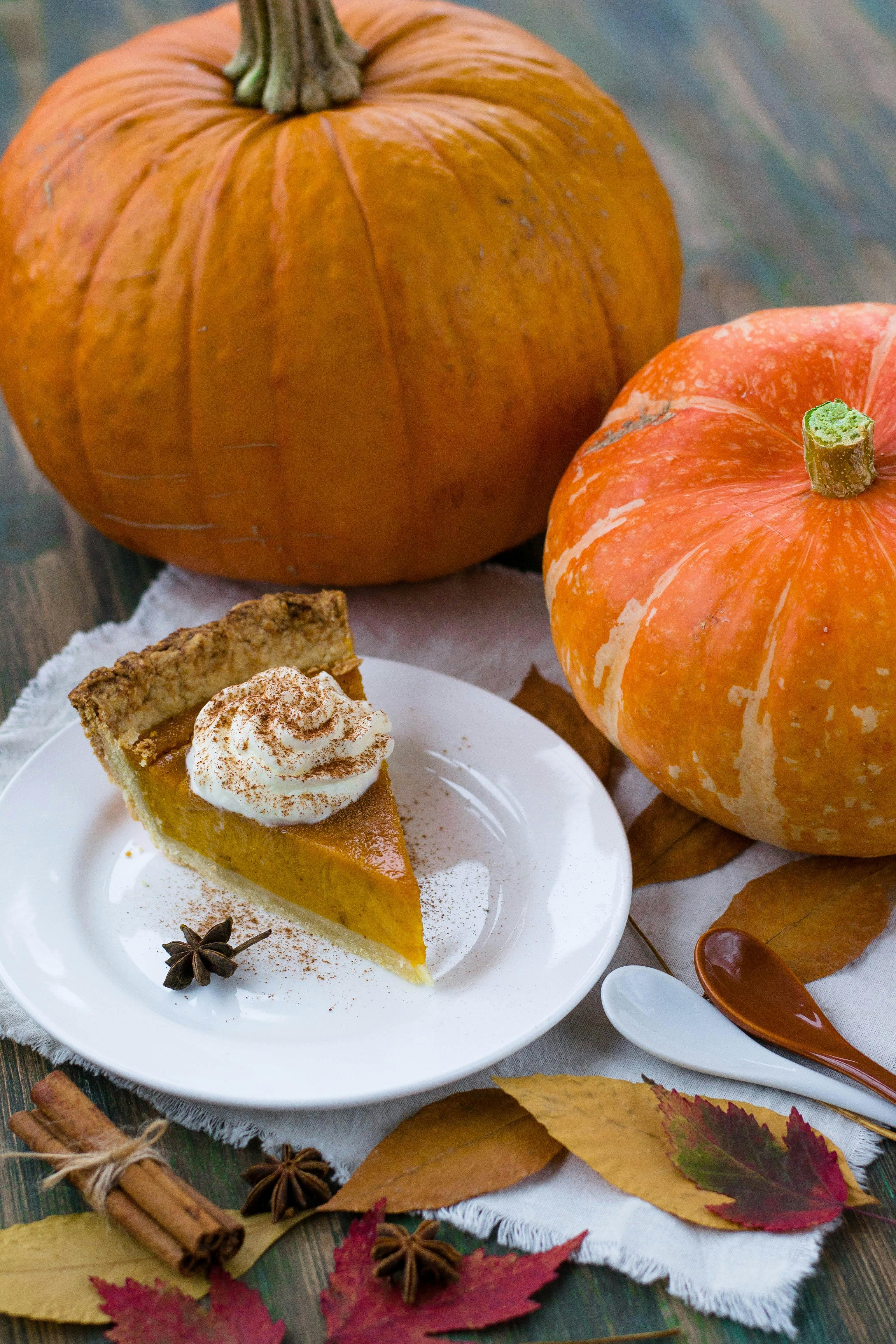 Close-up of a rustic pumpkin pie slice with visible caramel swirl, on a patterned ceramic plate