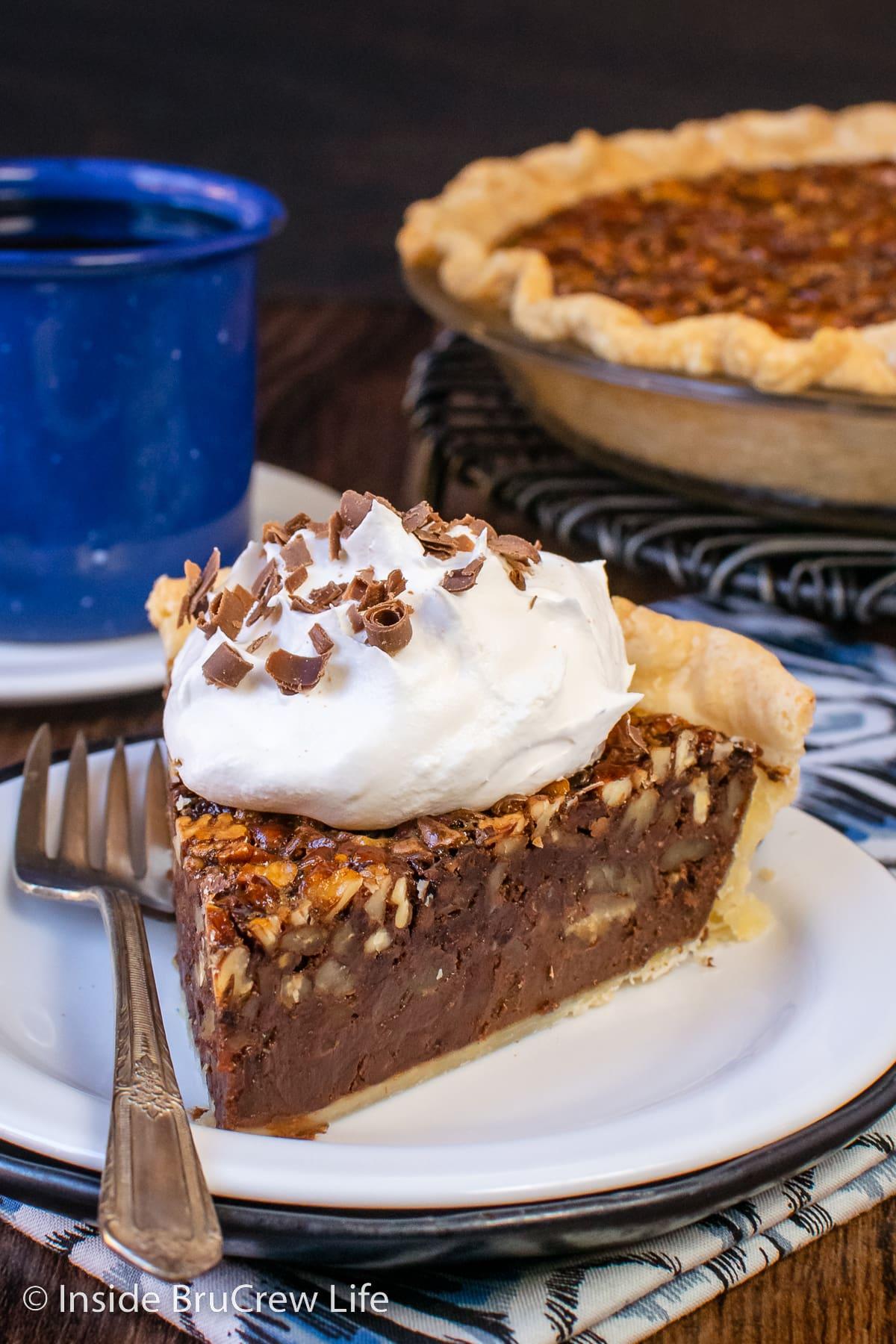 Decadent chocolate pecan pie slice with fudgy center, served with whipped cream