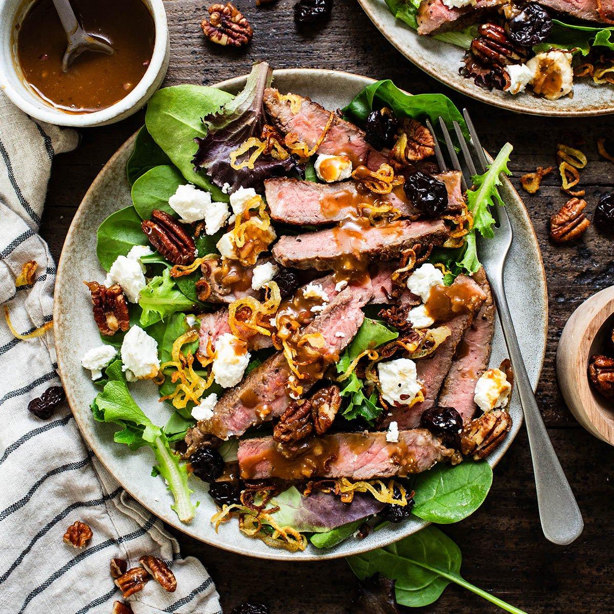Family enjoying steak salad outdoors