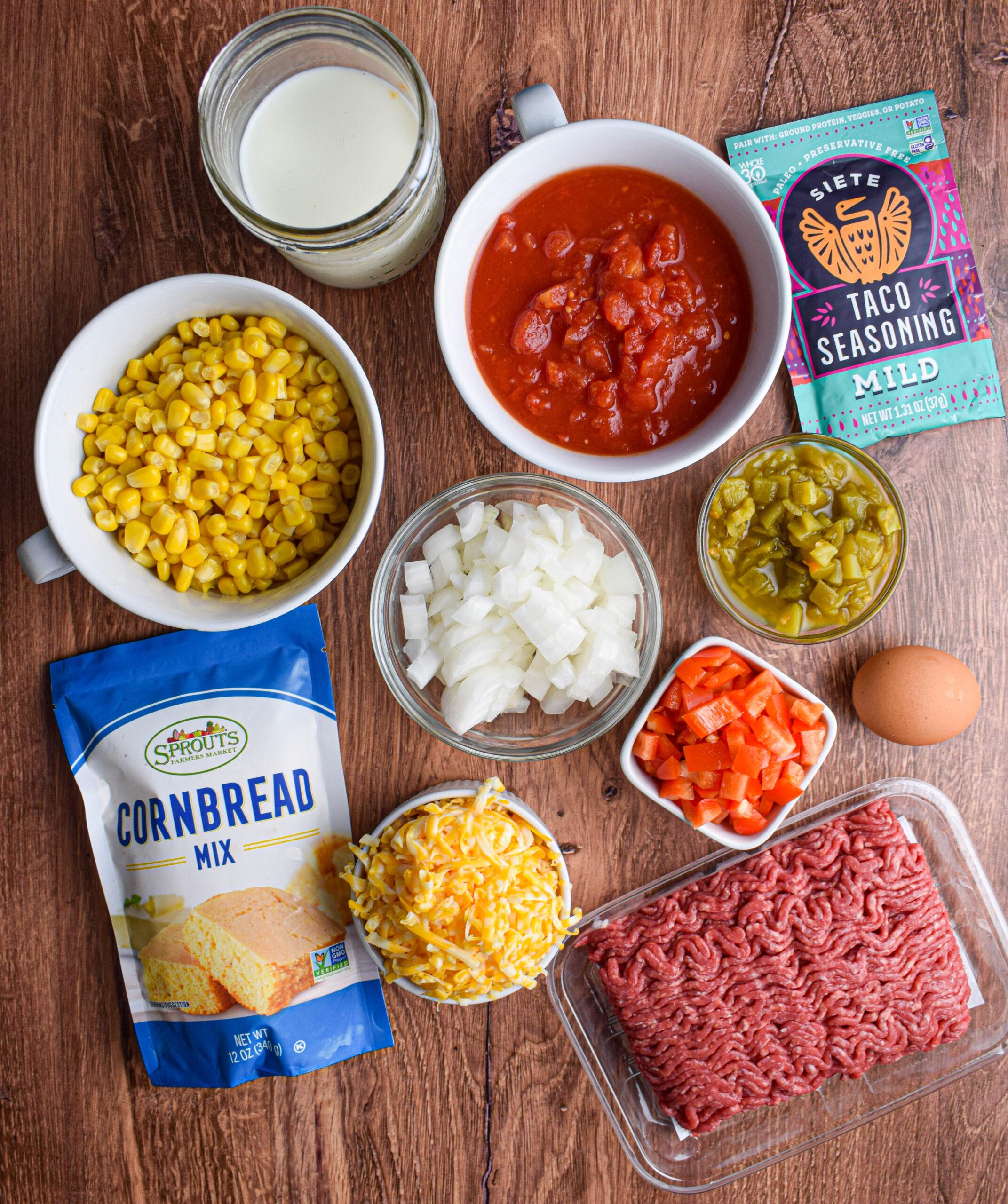 ingredients for beefy cornbread casserole arranged on a wooden table