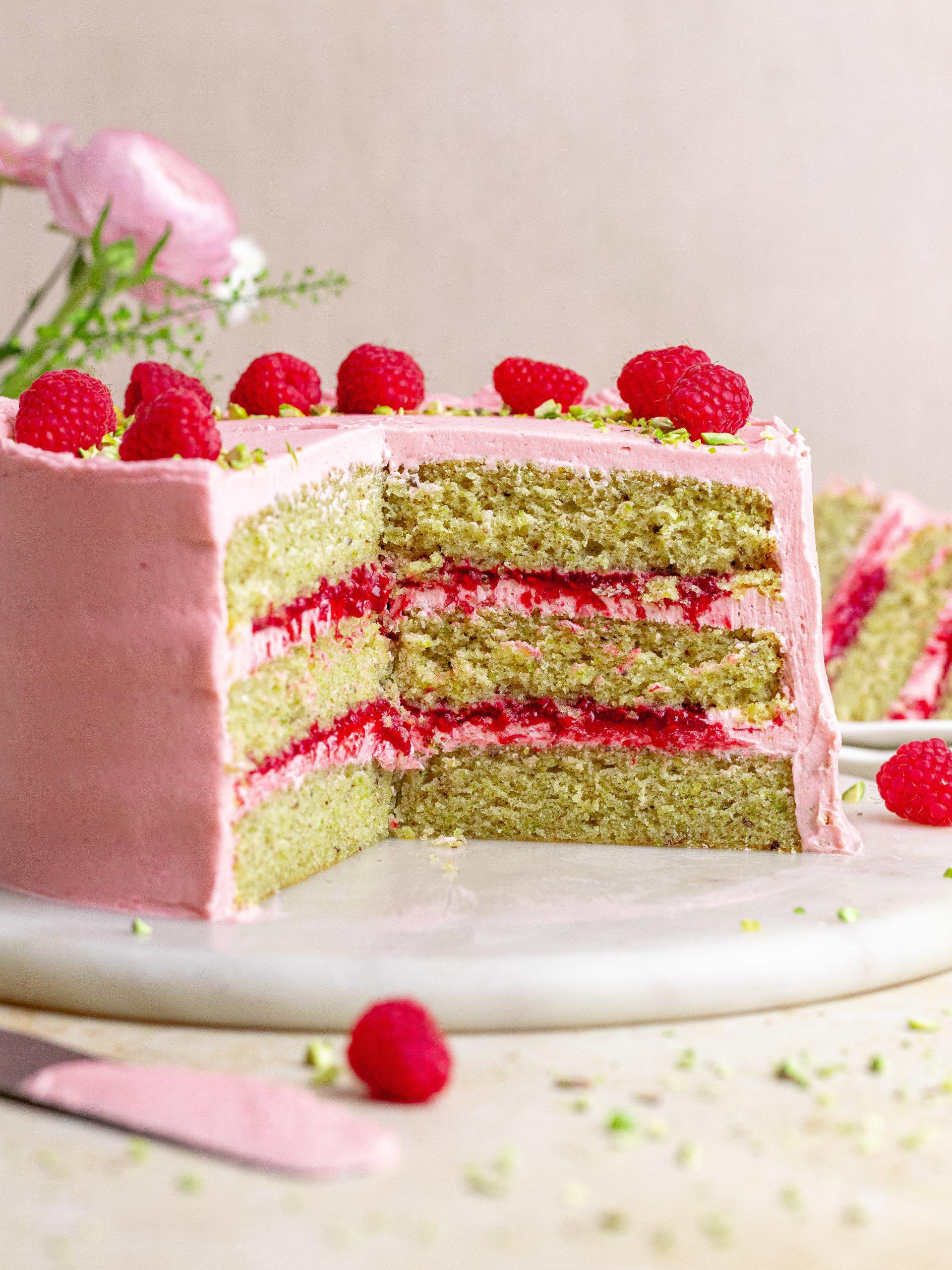 slices of the Graduate's Glory Cake being served, showcasing the layers of cake, raspberry jam, and buttercream