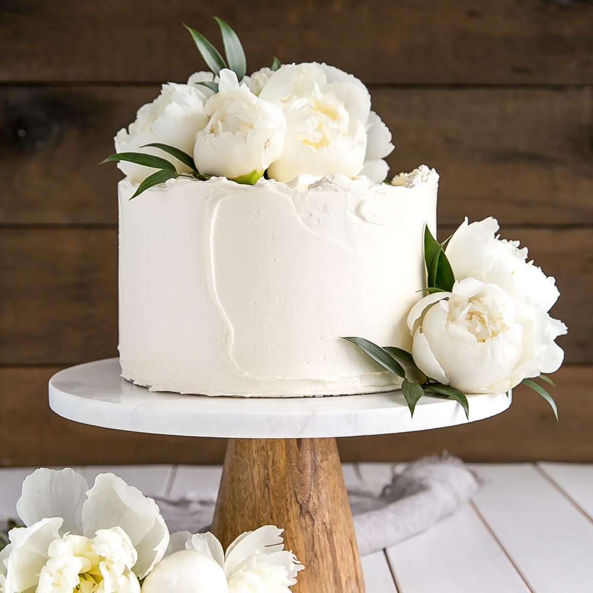 Elderflower Vanilla Birthday Cake with white frosting and edible flowers