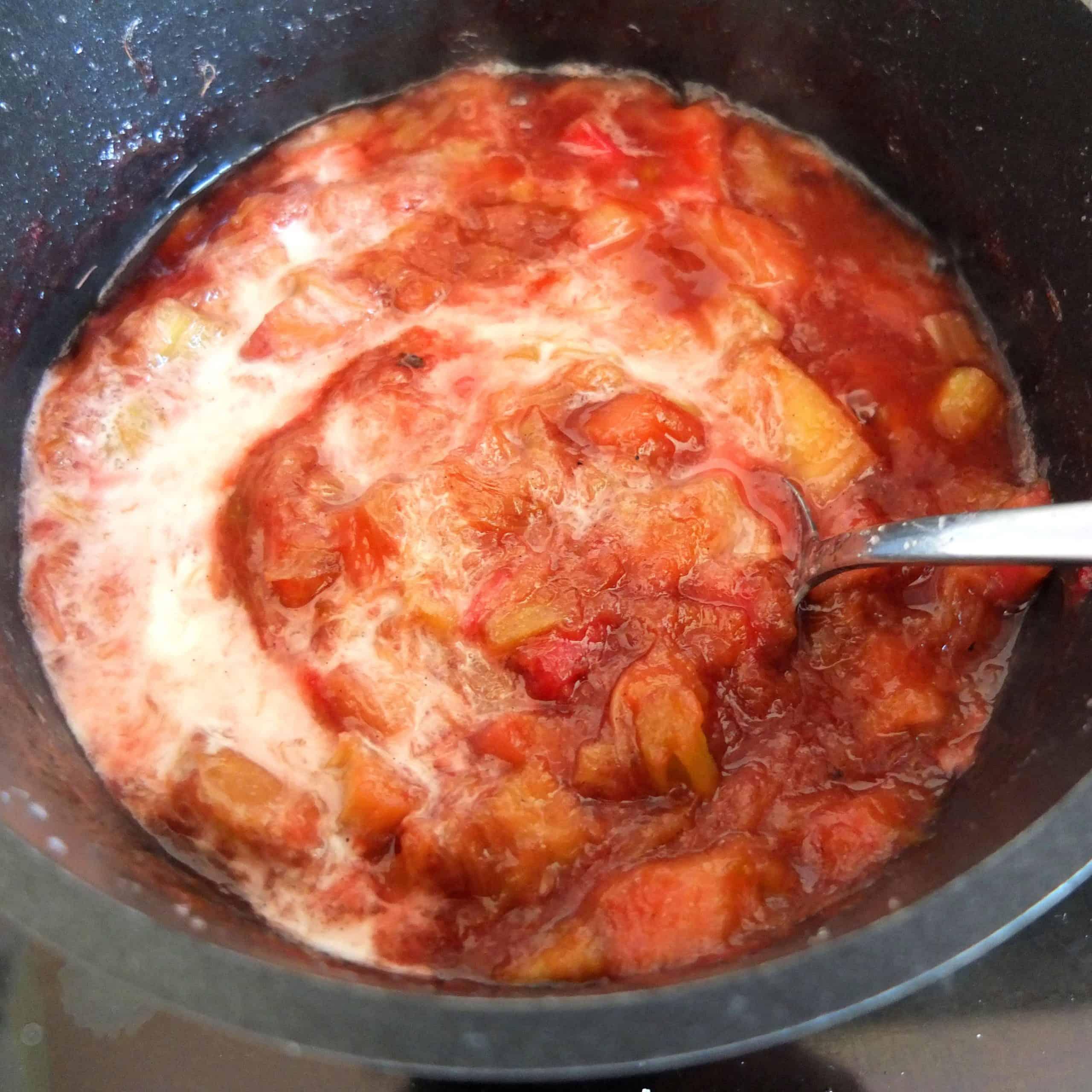 Close-up shot of simmering rhubarb compote in a saucepan