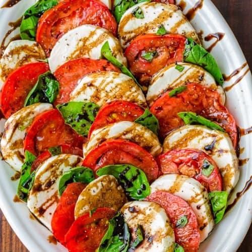 a chef preparing caprese salad with fresh ingredients
