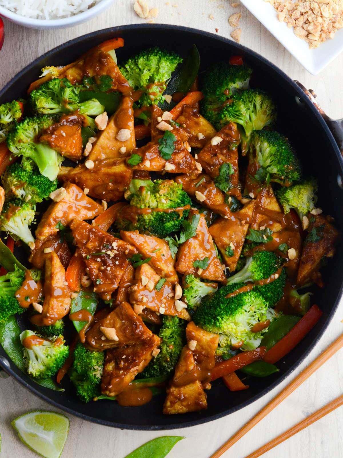 Overhead shot of the finished tofu stir-fry, garnished with peanuts and cilantro