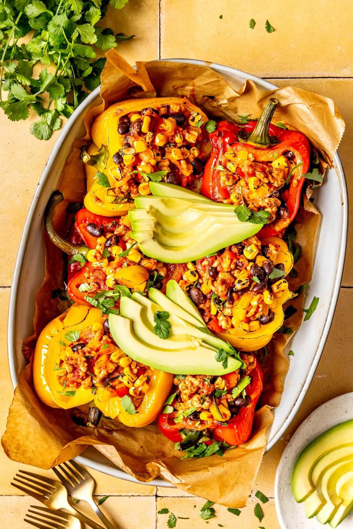 Overhead view of several Star Spangled Stuffed Peppers plated and ready to serve, highlighting their vibrant colors and presentation.