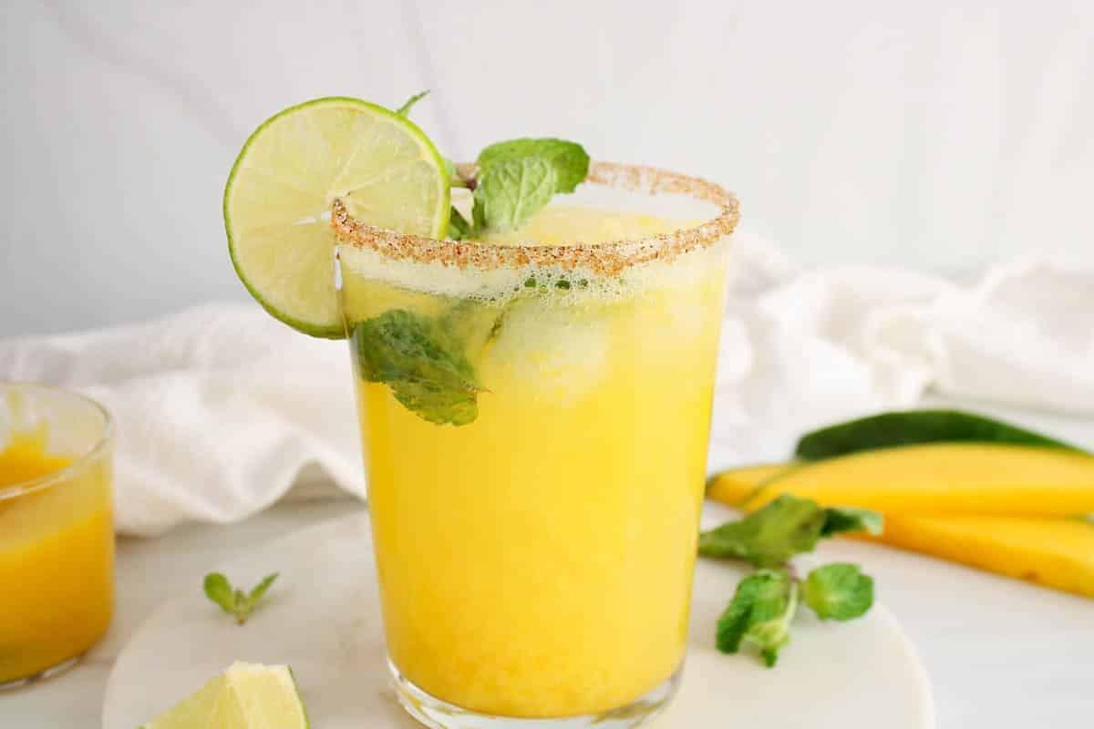 Vibrant mango mint cooler mocktail with holiday decorations, festive and bright