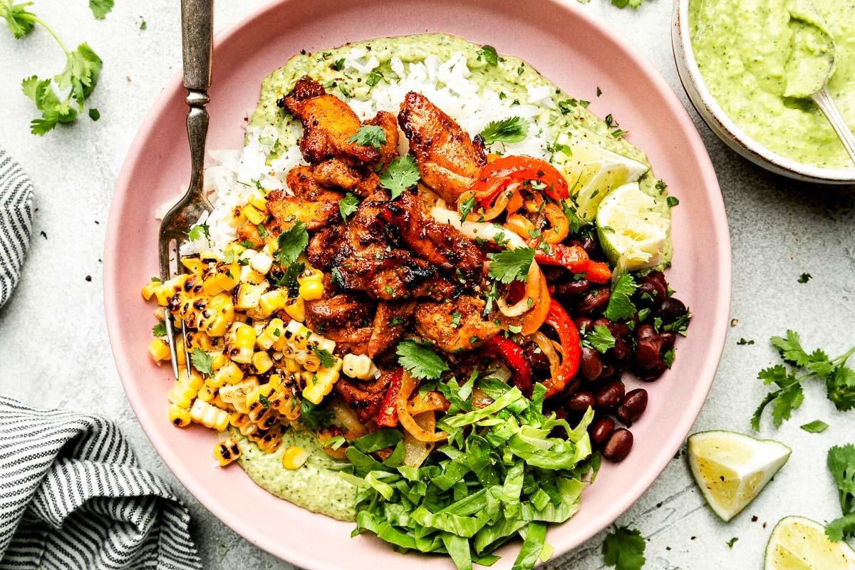 Overhead shot of a prepared Keto Chicken Fajita Bowl with avocado slices on top