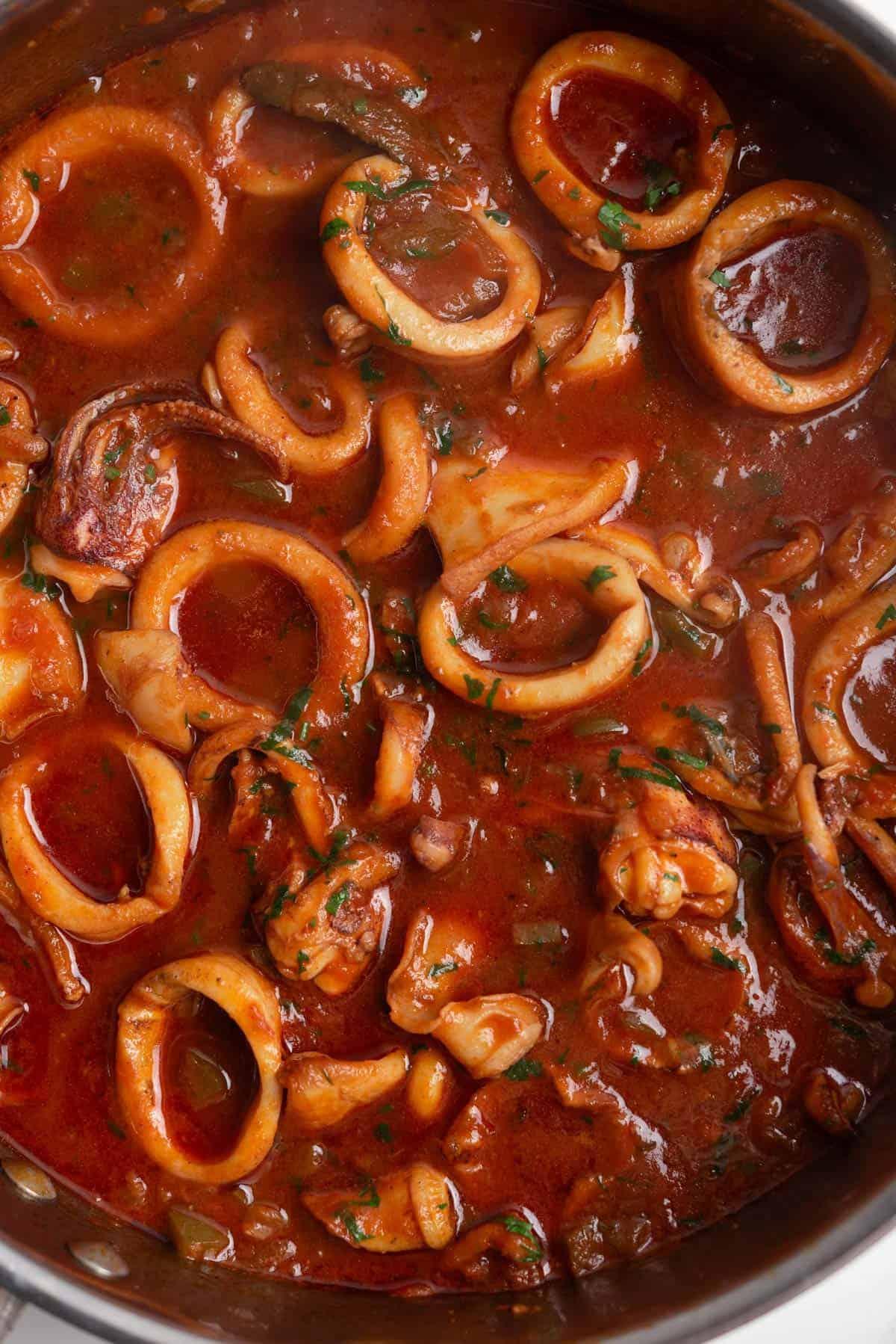 chef preparing tomato sauce with calamari