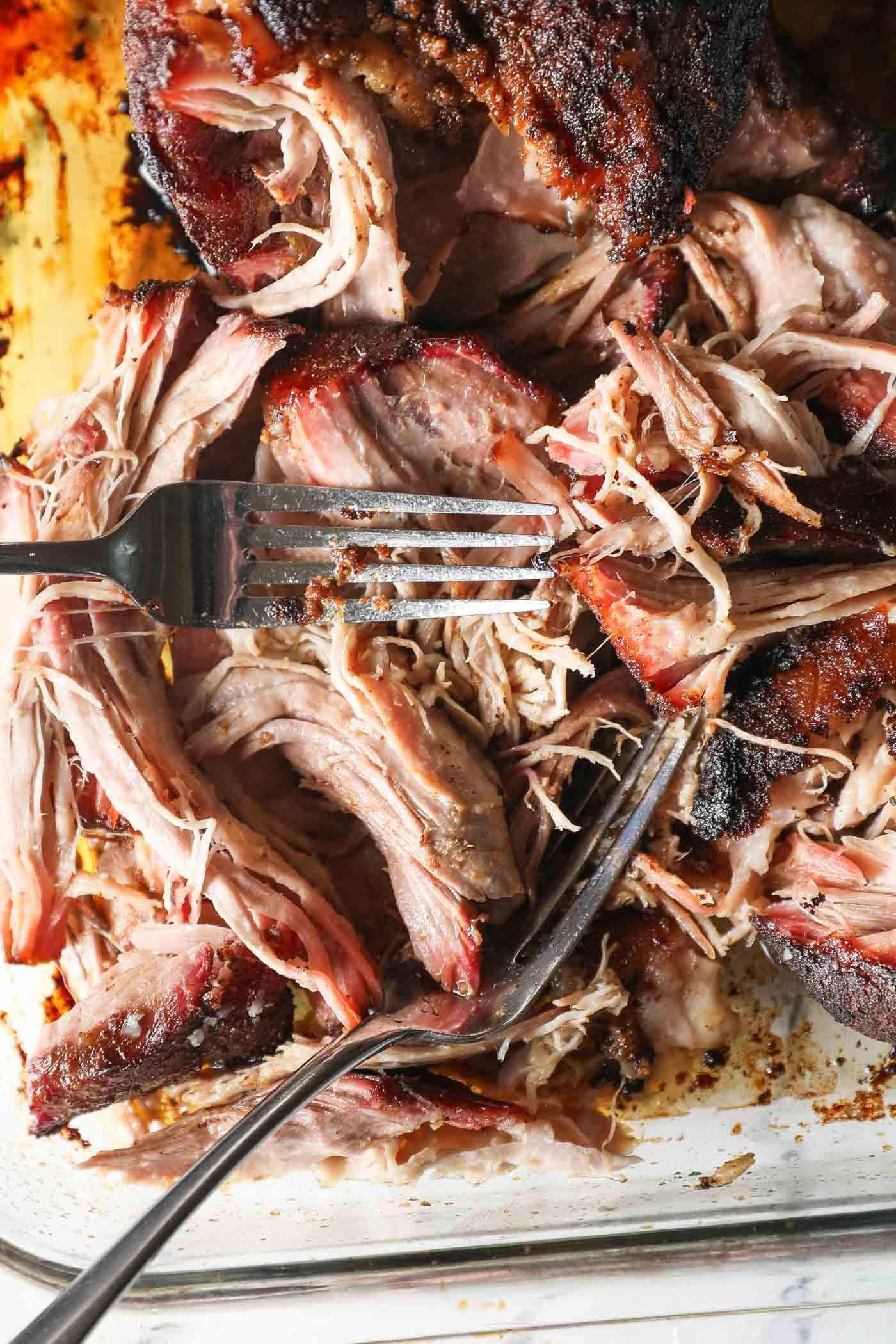 close up of pulled pork shoulder being shredded