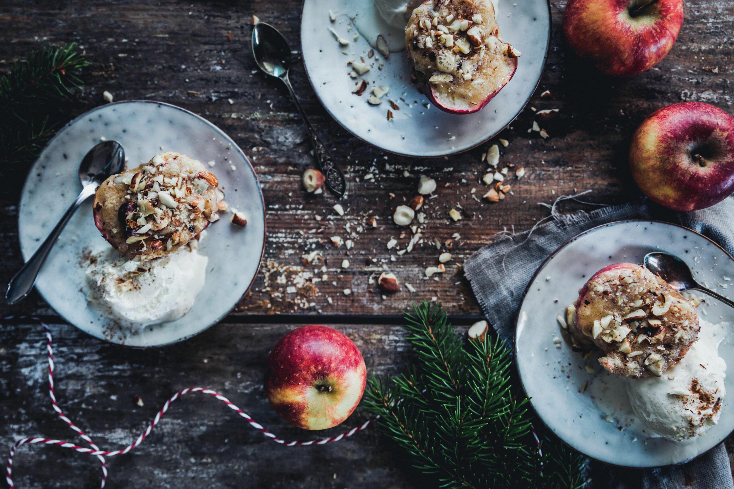 overhead shot of baked Rome apples with almond paste filling, arranged on a rustic wooden board
