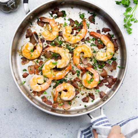 ingredients for bacon garlic butter shrimp laid out on a wooden surface