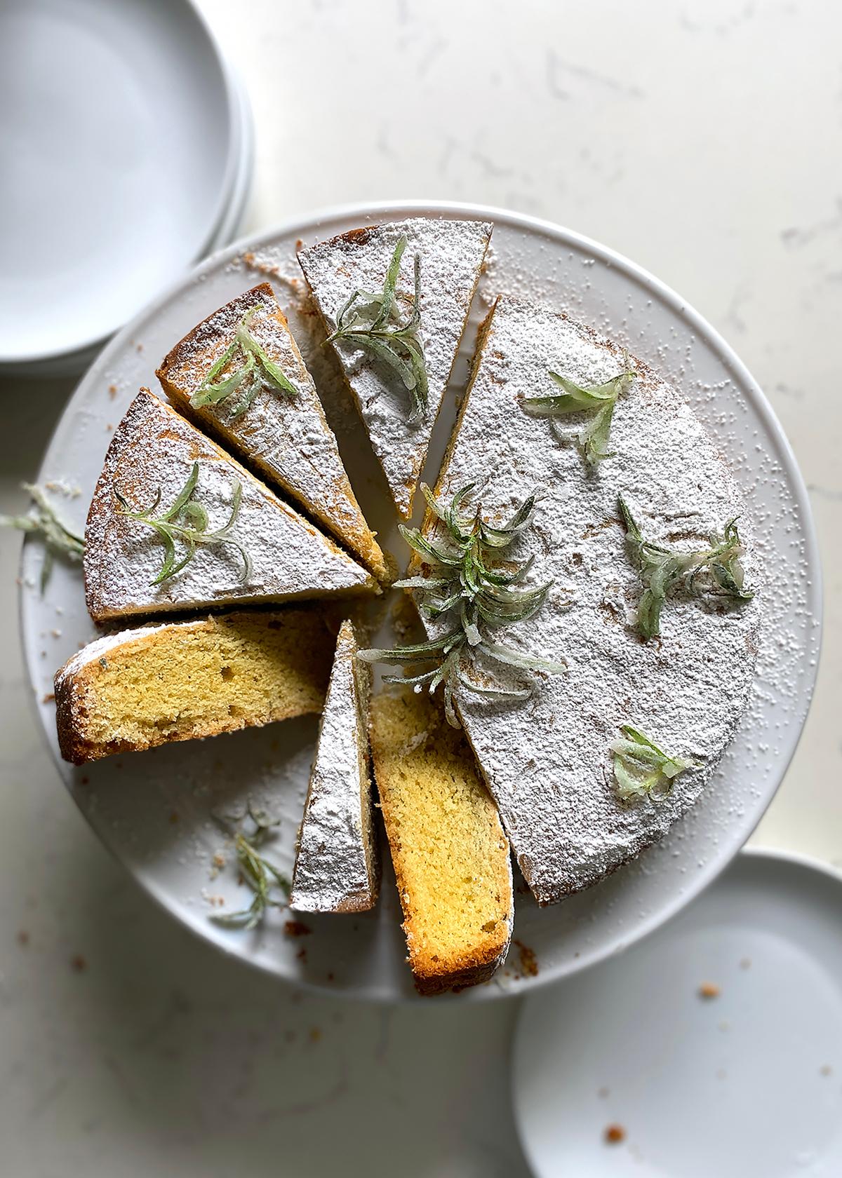a slice of Rosemary Rhubarb Olive Oil Cake with a sprig of rosemary
