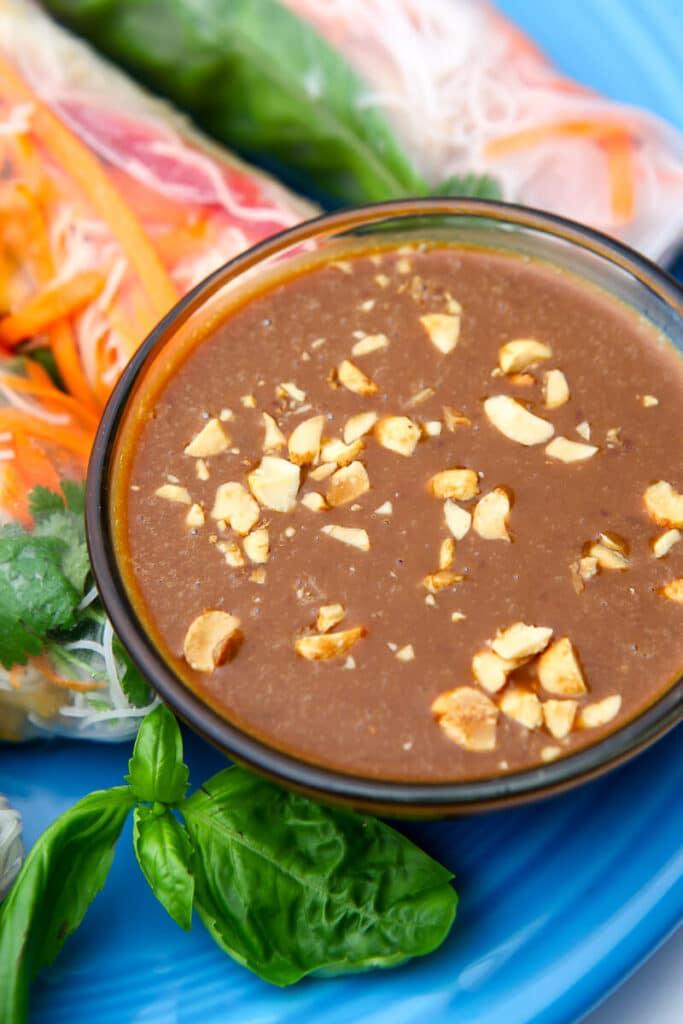 close-up of peanut dipping sauce with chopped peanuts and cilantro