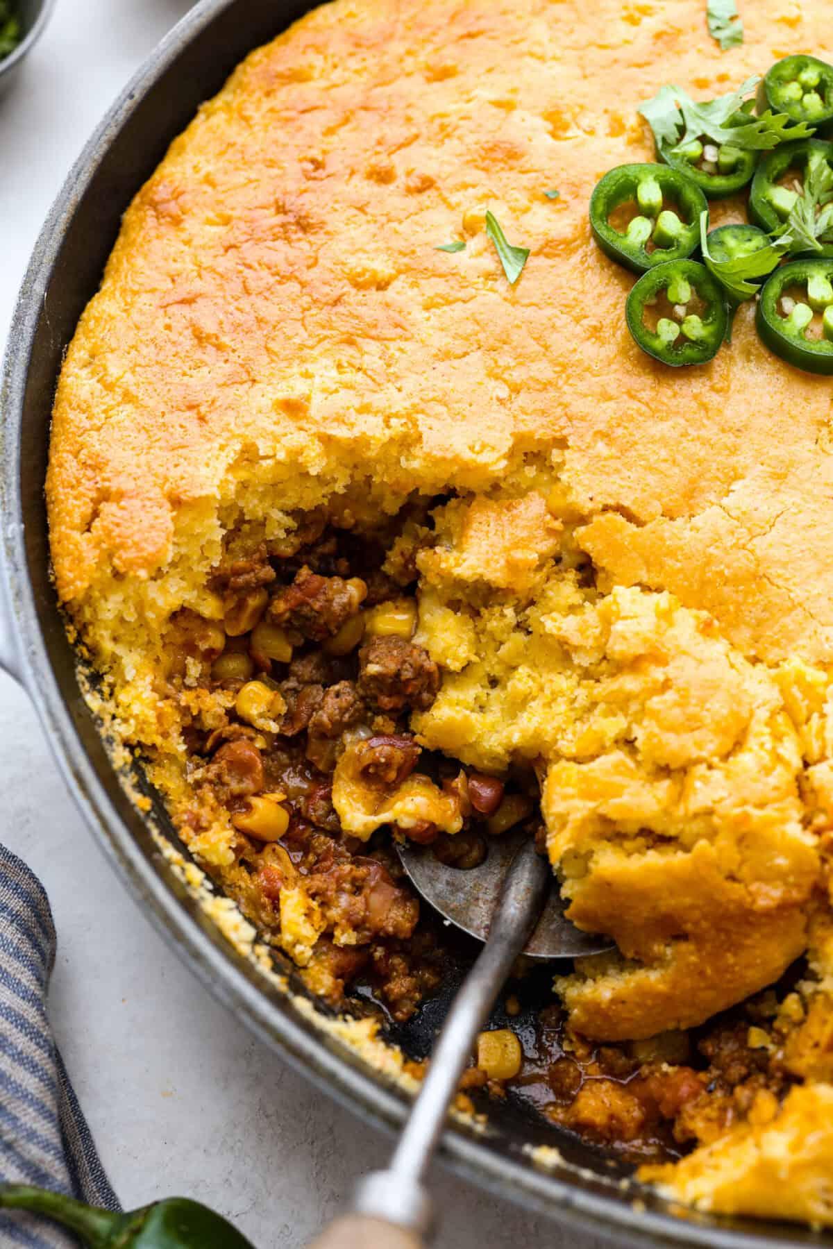 close up shot of a beefy cornbread casserole being served