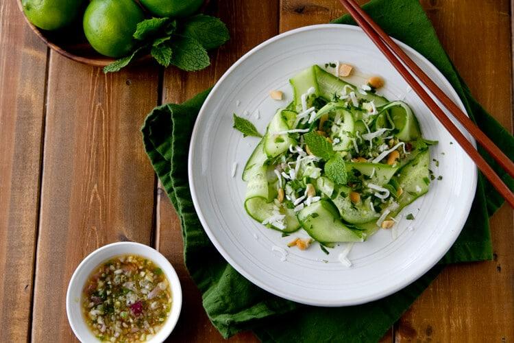 overhead view cucumber and hibiscus salad with a lime wedge