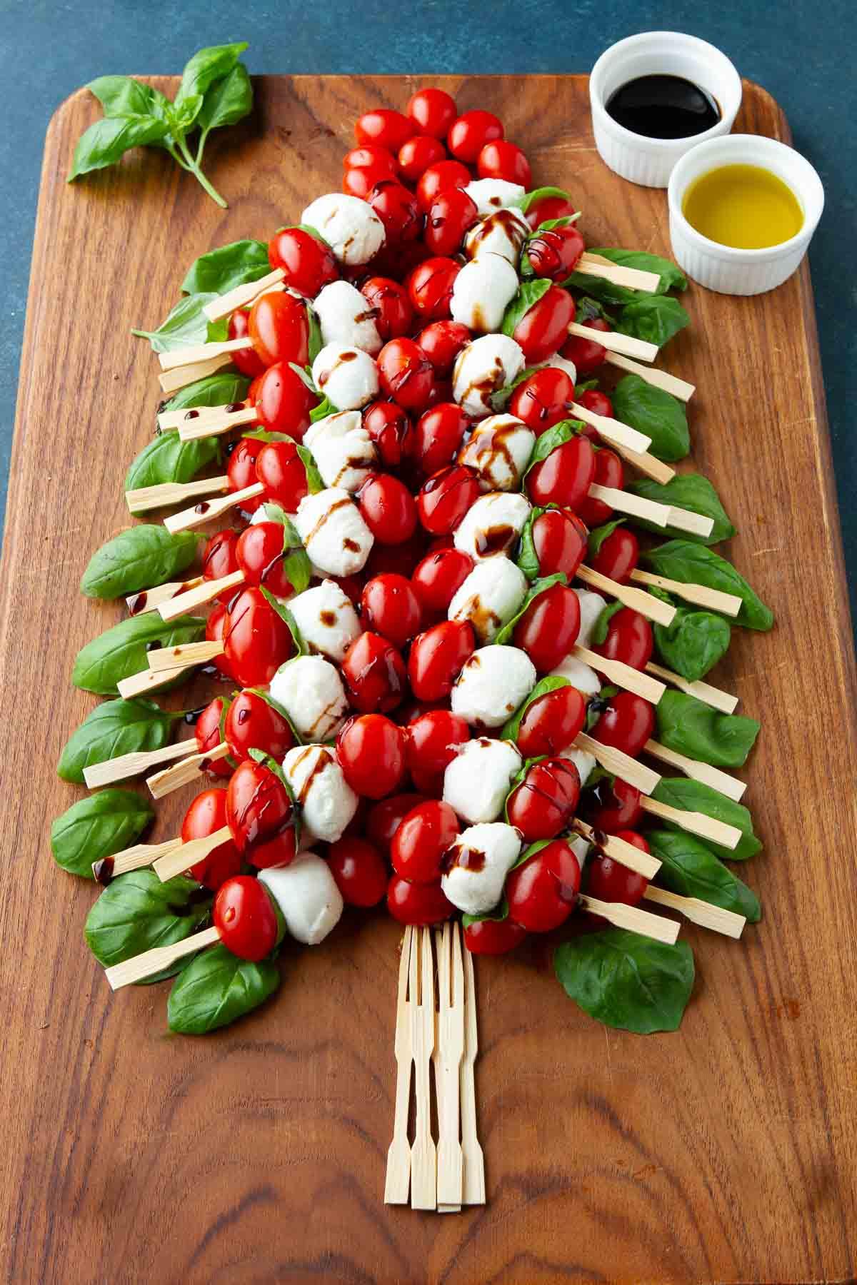 ingredients for caprese skewers laid out on a wooden board