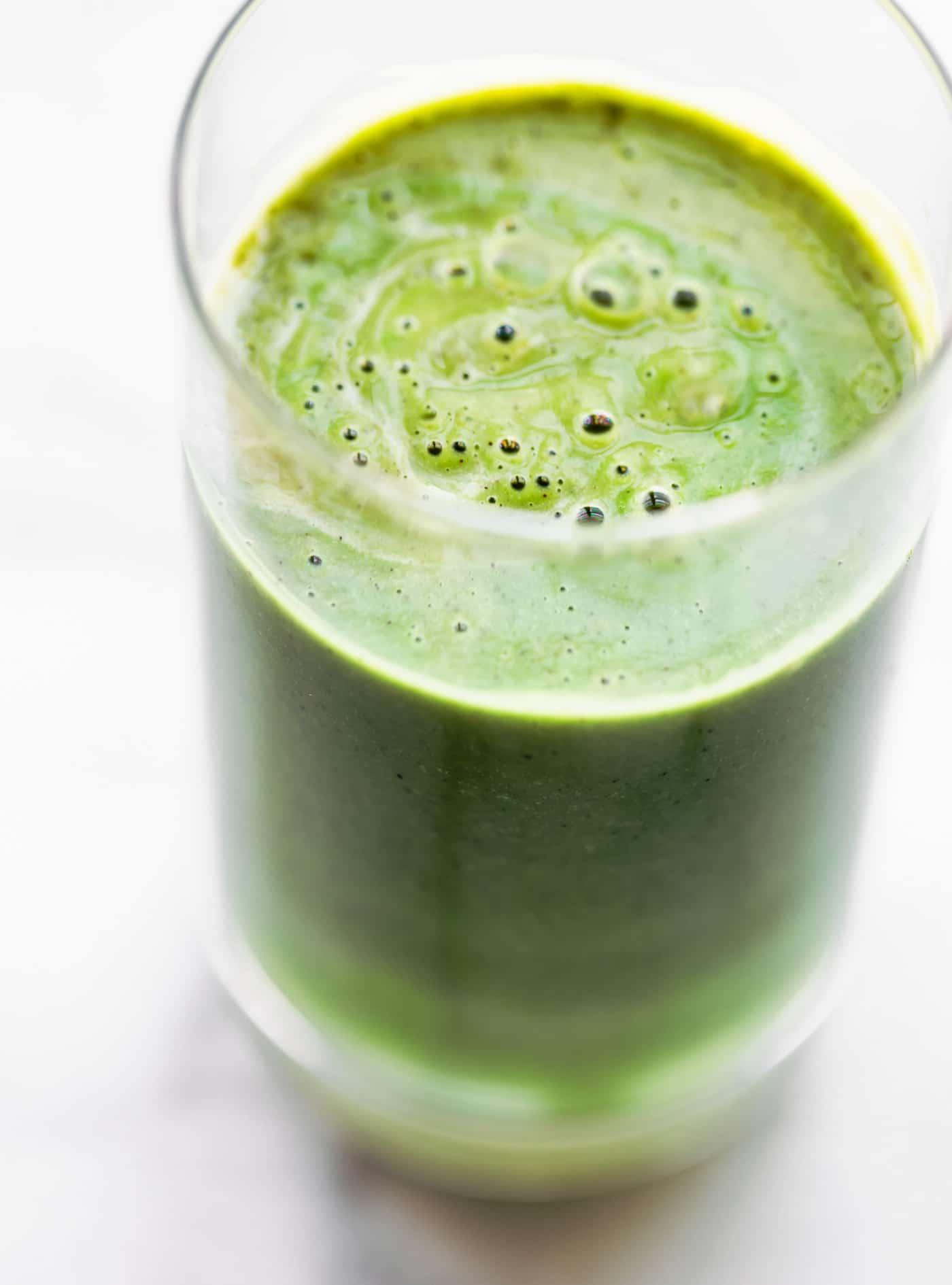 close-up shot of a glass of spirulina smoothie with visible texture