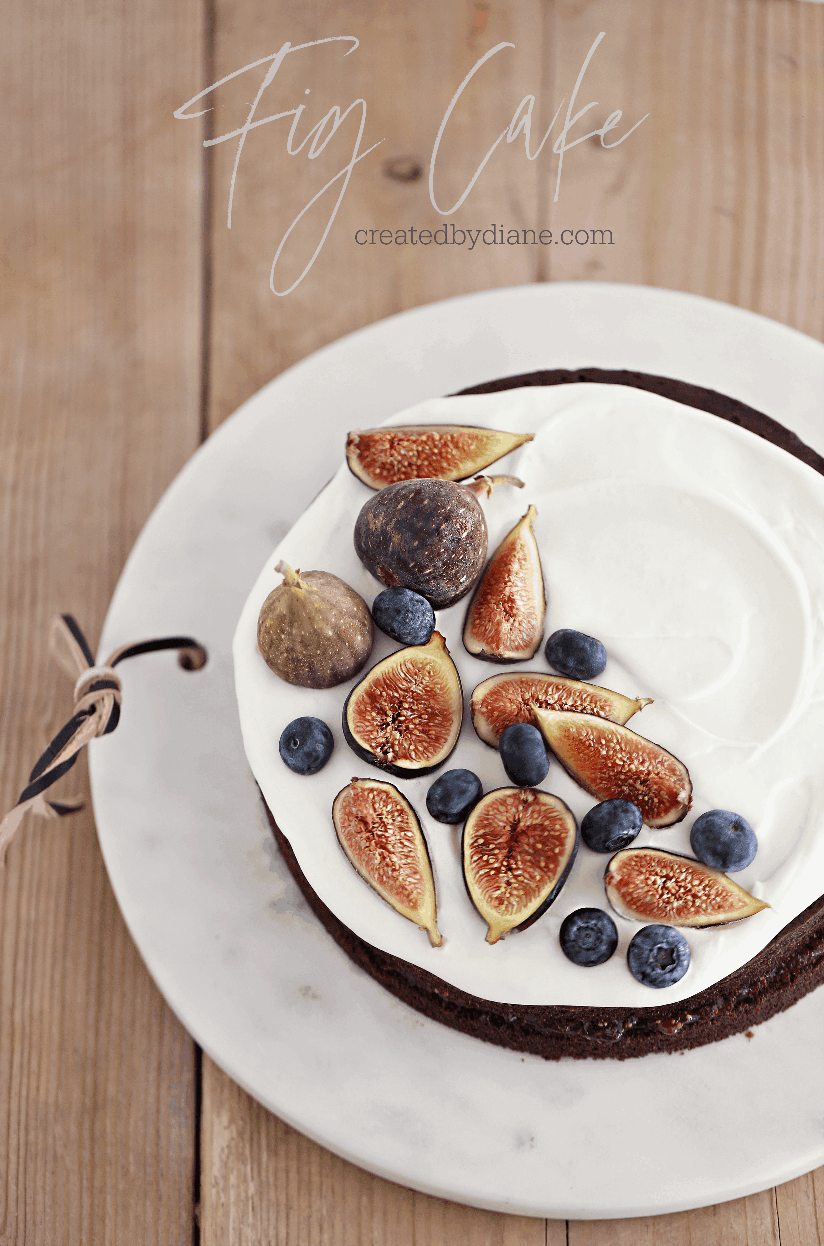 Overhead view of the completed Fig Balsamic Chocolate Layer Cake, decorated with fresh figs and a balsamic glaze.