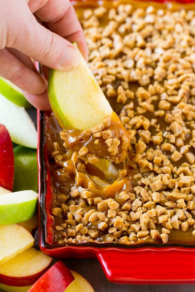 caramel apple dip with sliced apples and toppings