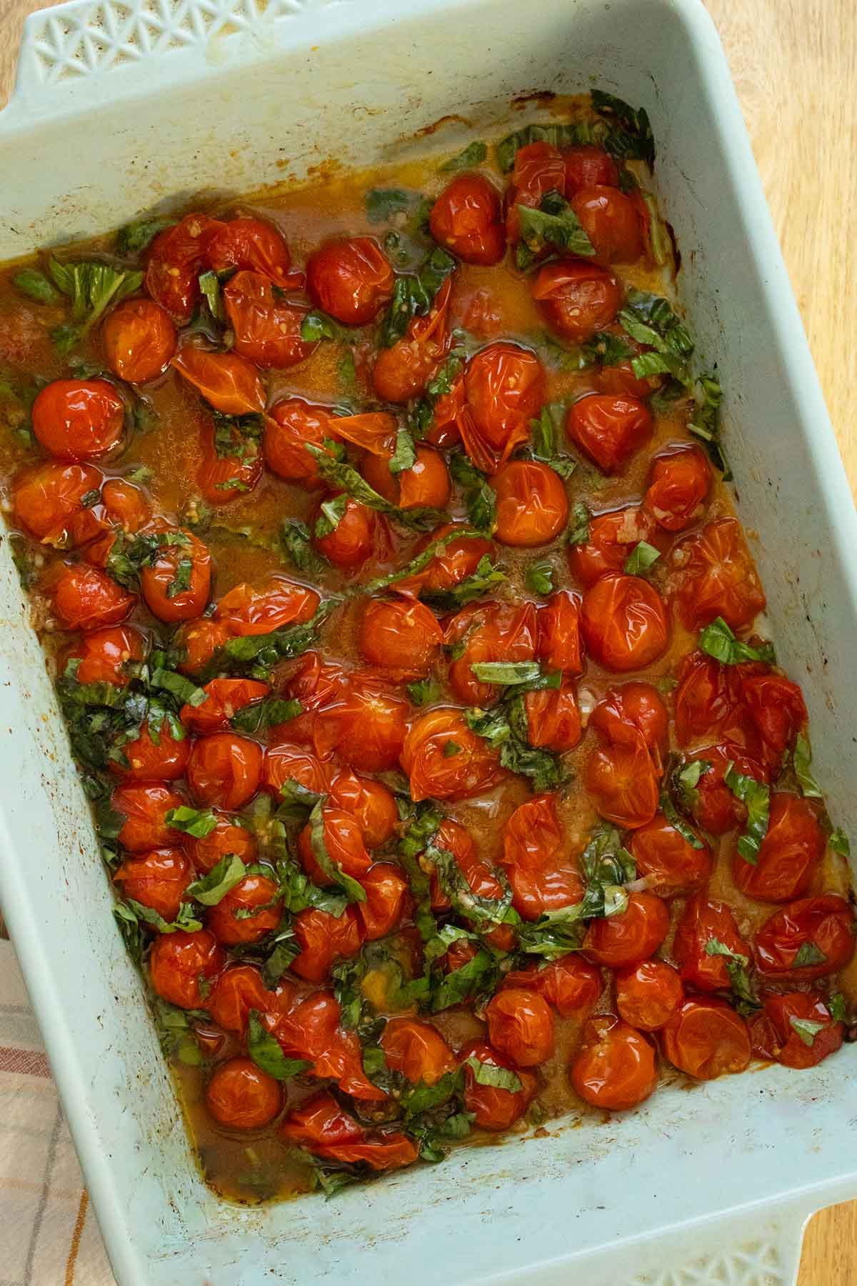 a pan of colorful cherry tomatoes roasting in the oven